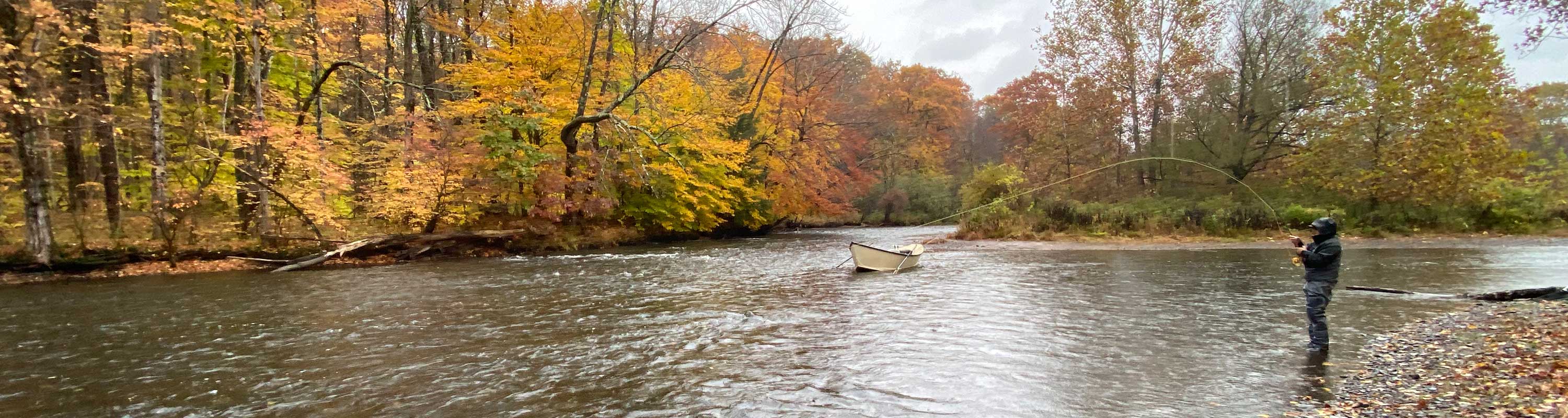photo of fisherman and a drifrwater fishing driftboat in salmon river in the fall