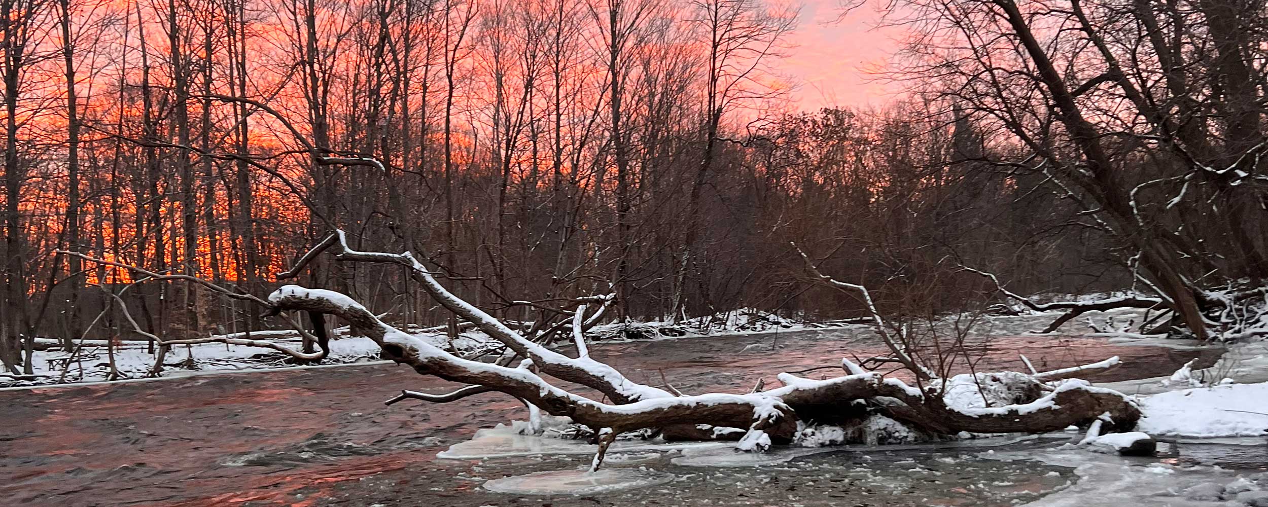 photo of orange and pink dawn over Salmon River in winter